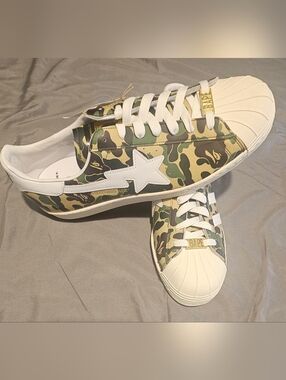 The adidas Superstar A Bathing Ape ABC Camo Green features a Green ABC Camo leat